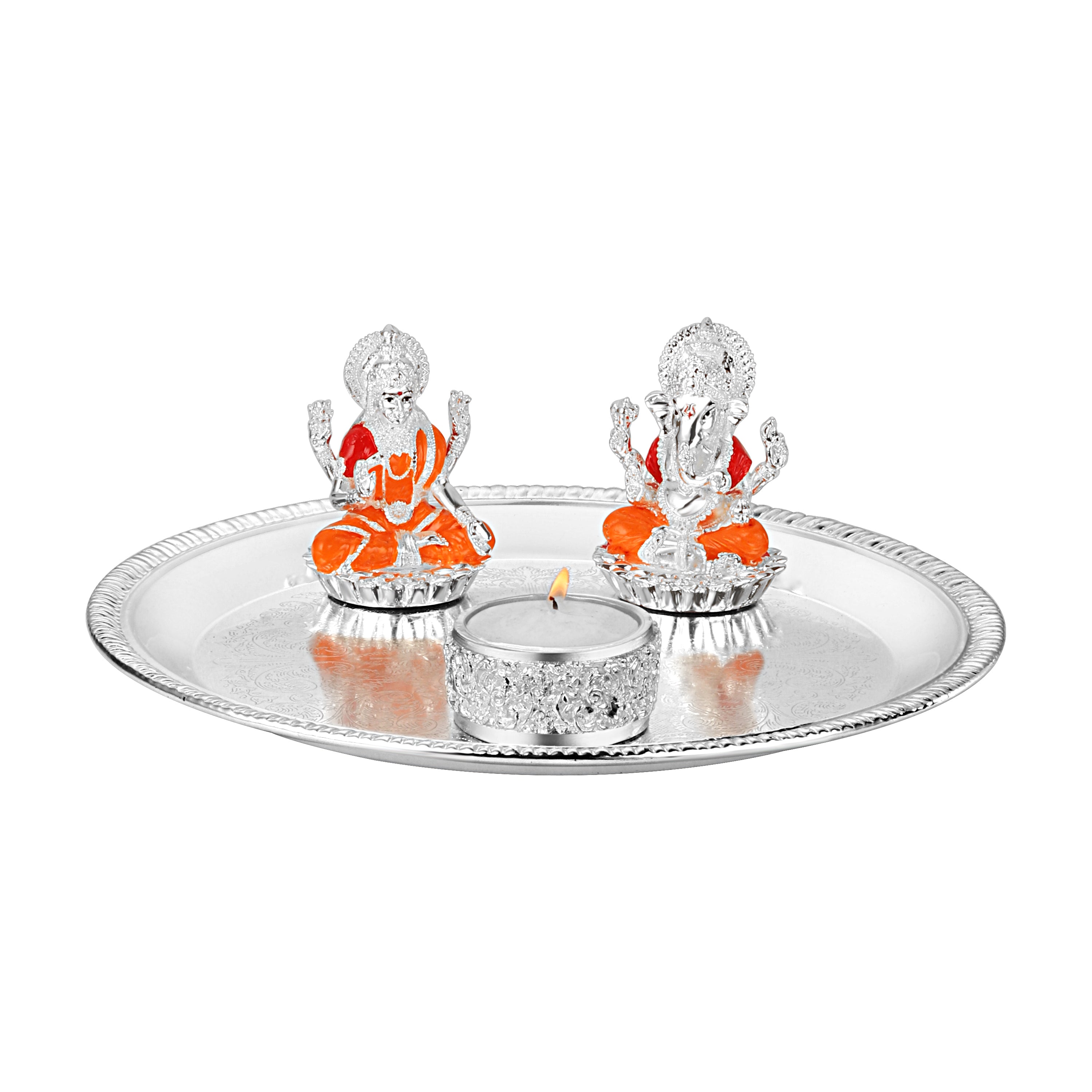 Puja thali with lakshmi ganesha on chowki & tea light.