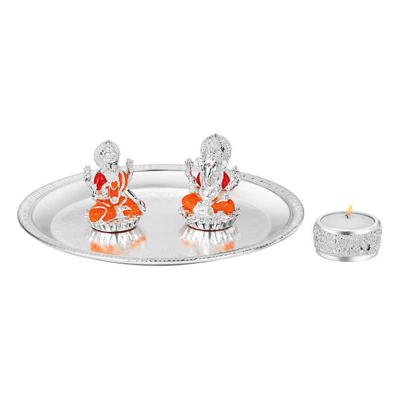 Puja thali with lakshmi ganesha on chowki & tea light.