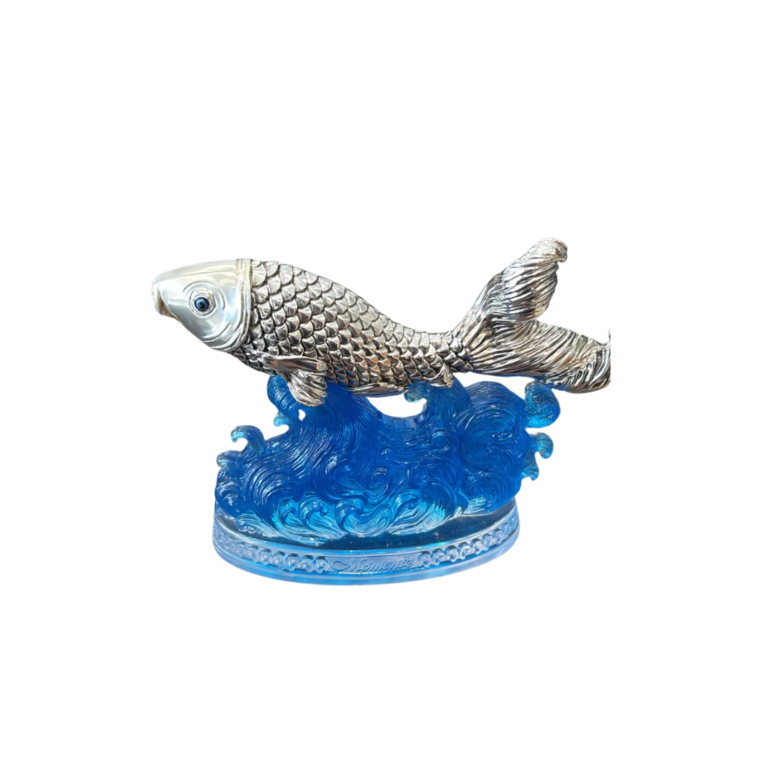 Silver-Plated Fish Figurine on Blue Ocean Waves